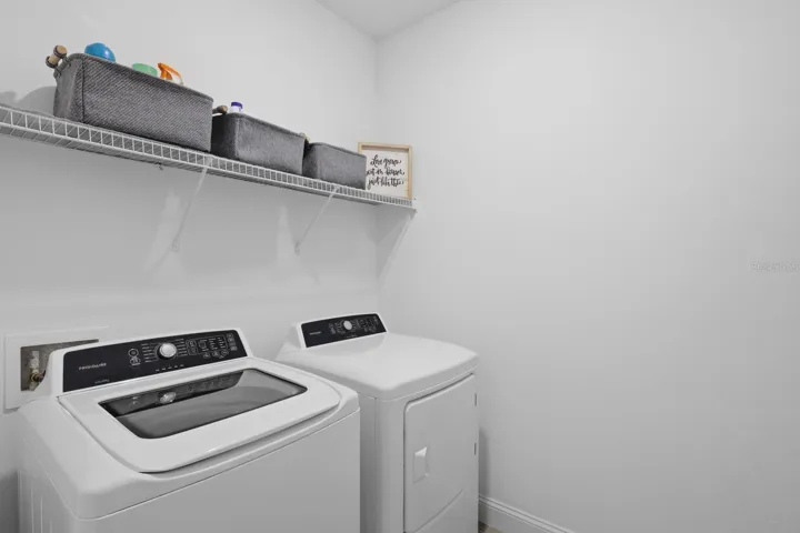 Laundry room features a washer & dryer that are staying with this home.