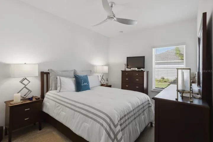 The spacious third bedroom holds another large set of furniture with a bypass door closet.