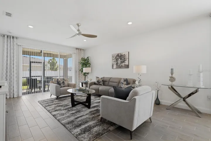 This space is a wonderful family gathering space. Easily can hold a sectional sofa if needed. Gray plank style tile is just gorgeous in this house.