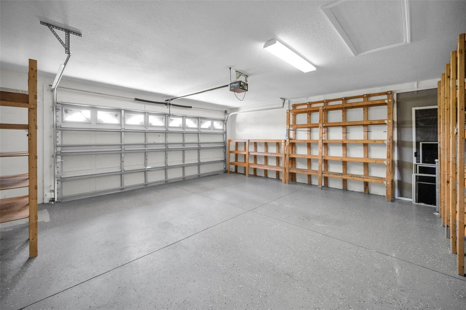 LARGE TWO CAR GARAGE WITH PLENTY OF ROOM FOR STORAGE.