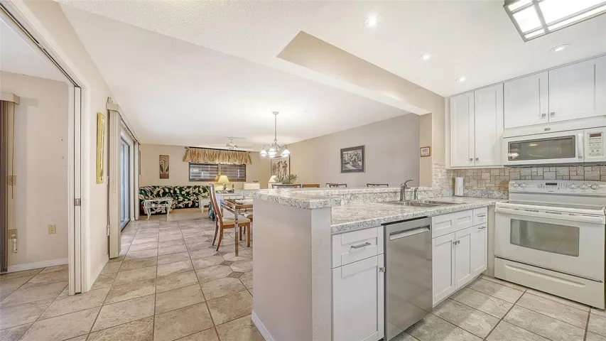 kitchen, dining room, living room after exiting foyer