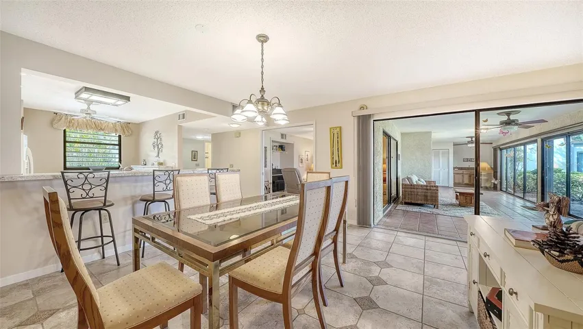 dining room with lanai in back ground. Entrance to den/possible 3rd BR is to left of lanai entrance