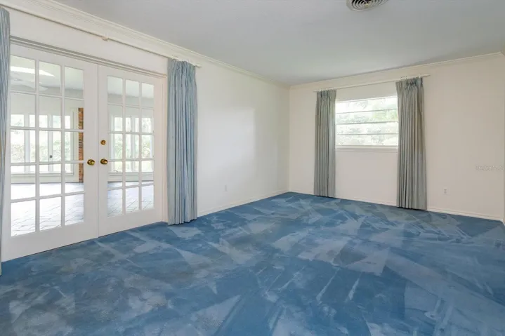 Primary Bedroom has french doors to Florida Room
