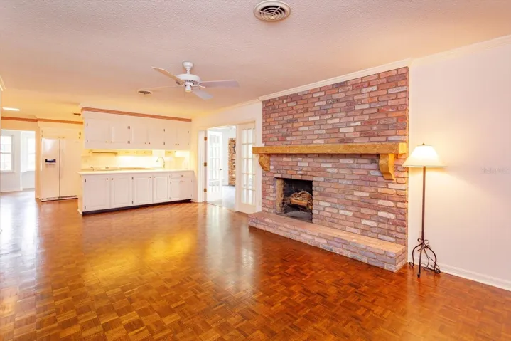Family Room is open to Kitchen and has custom mantle over brick fire place