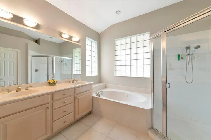 primary bathroom with tub and seperate shower