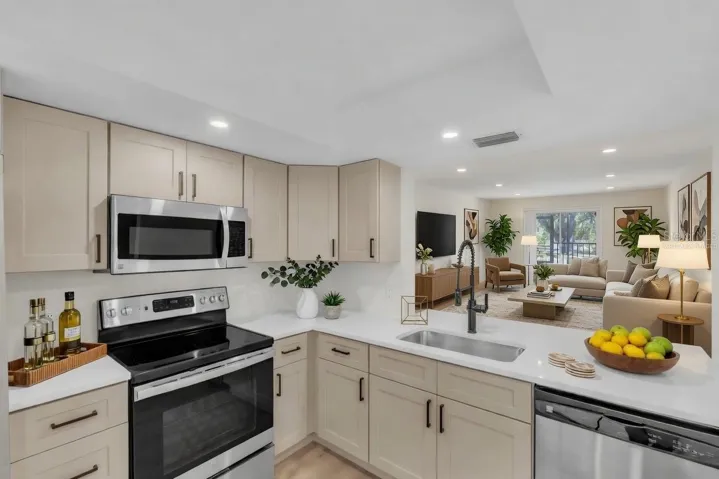 Kitchen with quartz countertops, stainless steel appliances, and an open pass-through to the living area - virtually staged