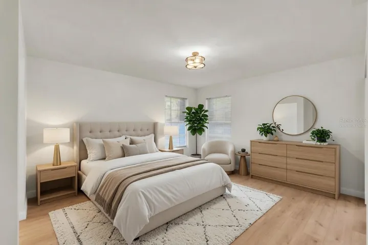Spacious owner's suite with luxury flooring, natural light, and private lanai access - virtually staged