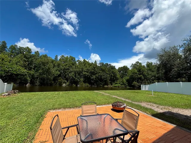 Serene backyard with waterfront and nature view.