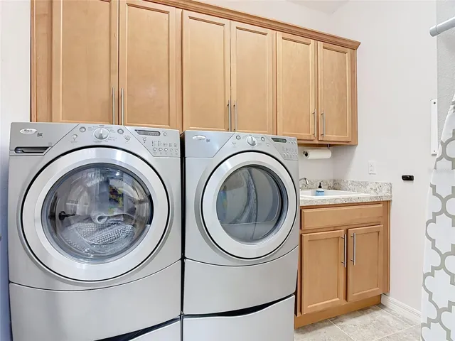 Laundry room with plenty of cabinets