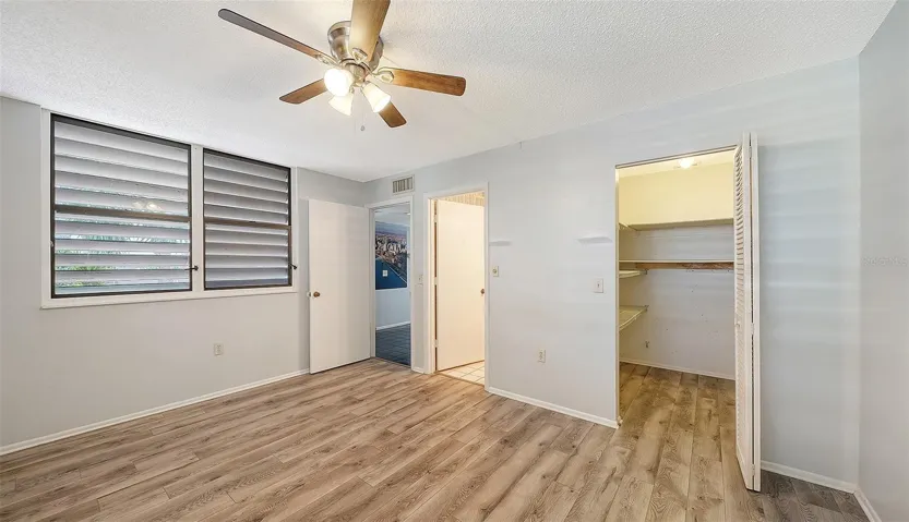 guest bedroom with walk in closet and ensuite bath