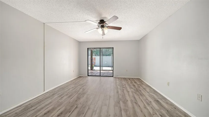 Master bedroom with sliders to lanai and view of couryard