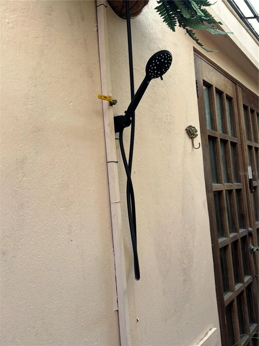 Outdoor shower in entry passageway - great for sandy feet after a day a the beach!