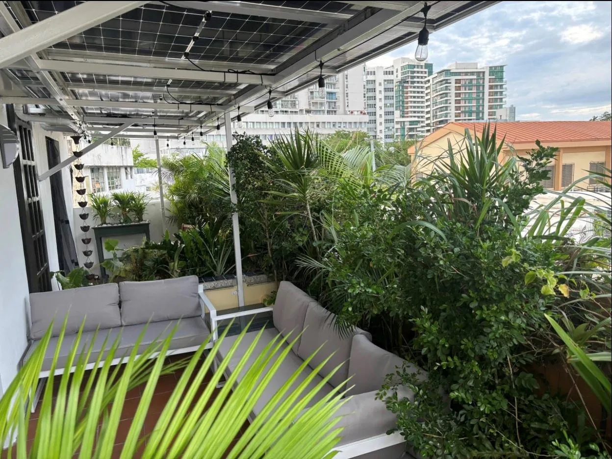 Penthouse terrace with view of Ciudadela complex in the background.
