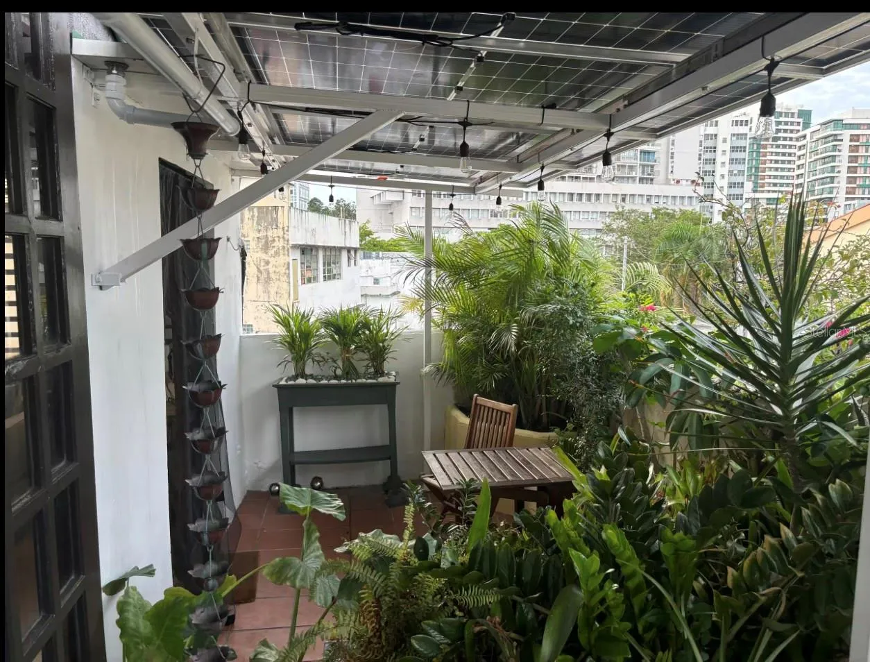Solar panels protect penthouse terrace from tropical sun.