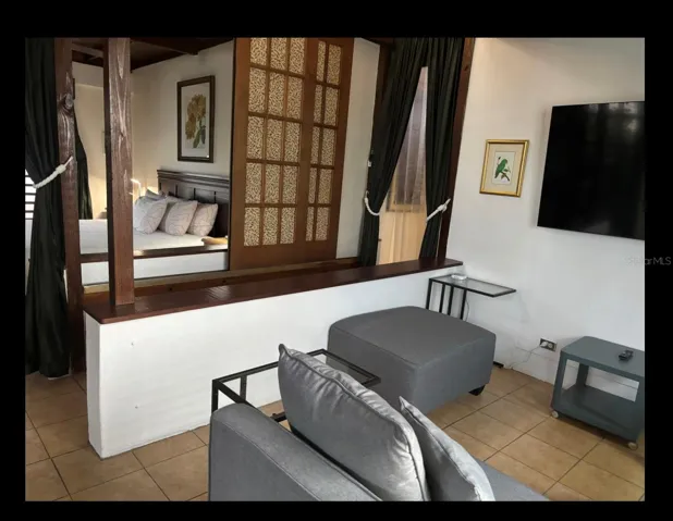 Penthouse living room looking to the partition and bedroom.