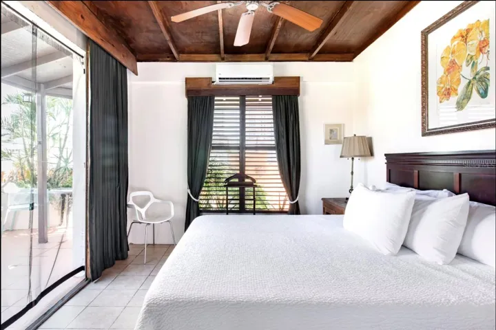 Penthouse bedroom with direct access to terrace gardens and outdoor living area.