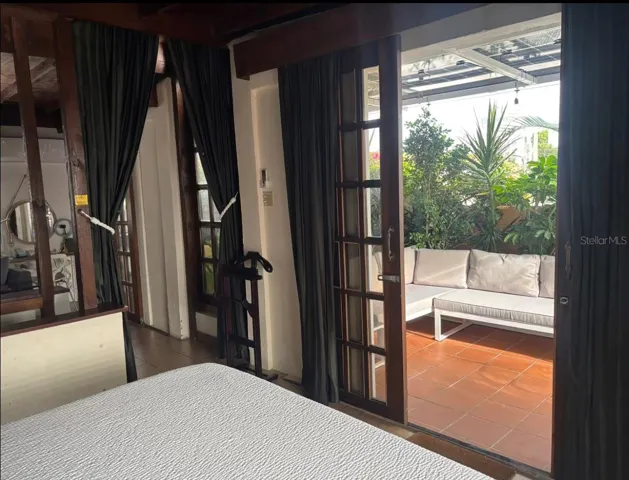 Penthouse view from bedroom to outdoor living room.