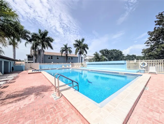 Spacious pool with a nice water fall on the wall at the other side, how relaxing!