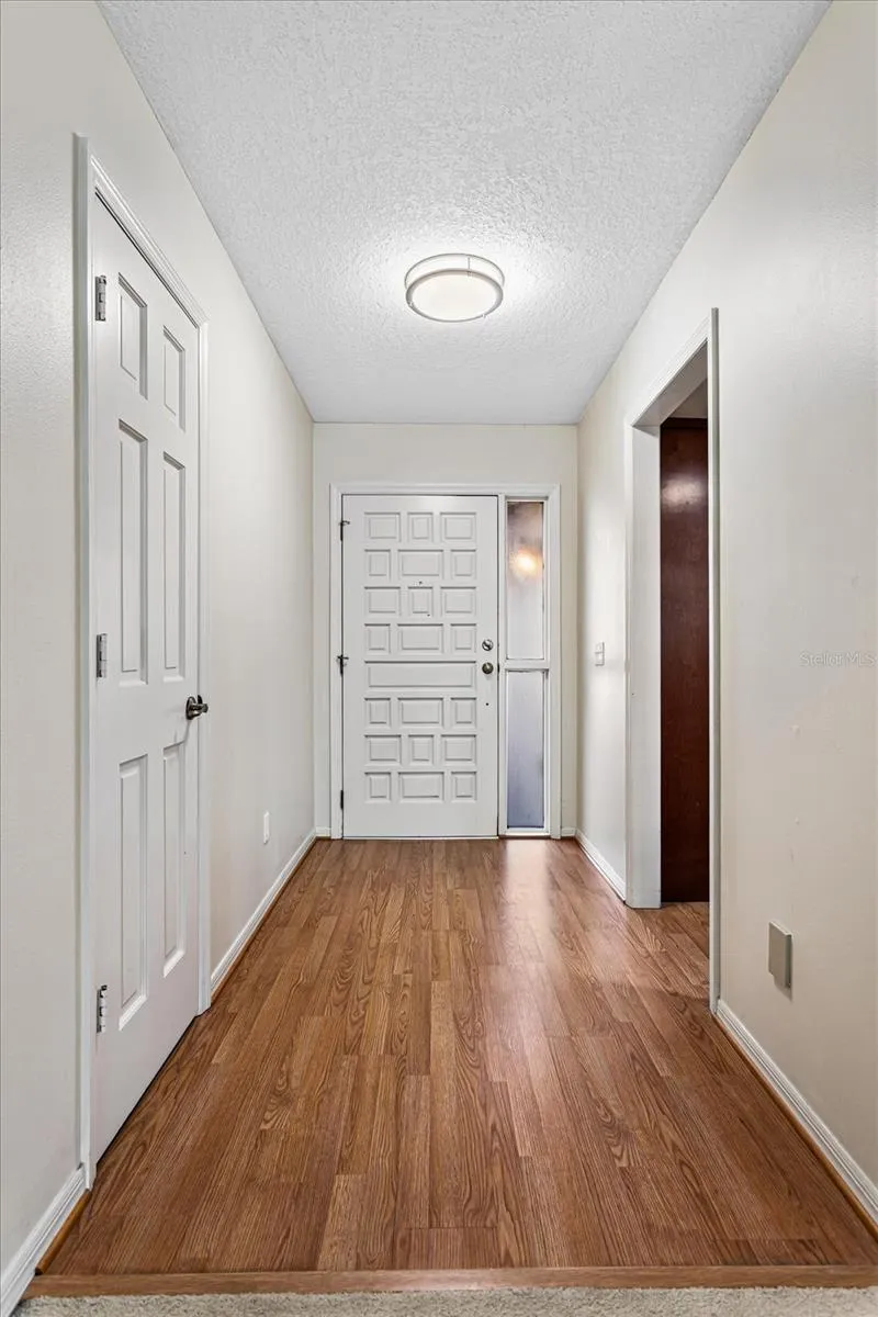 Foyer with coat closet, opens to kitchen and great room