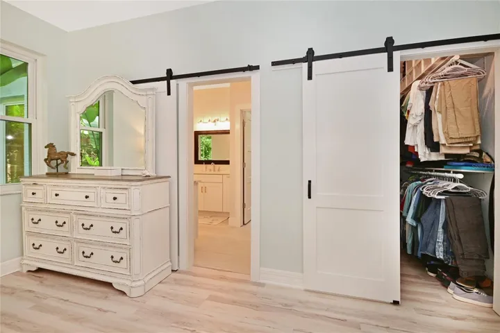 Barn doors to en suite bathroom and second closet.