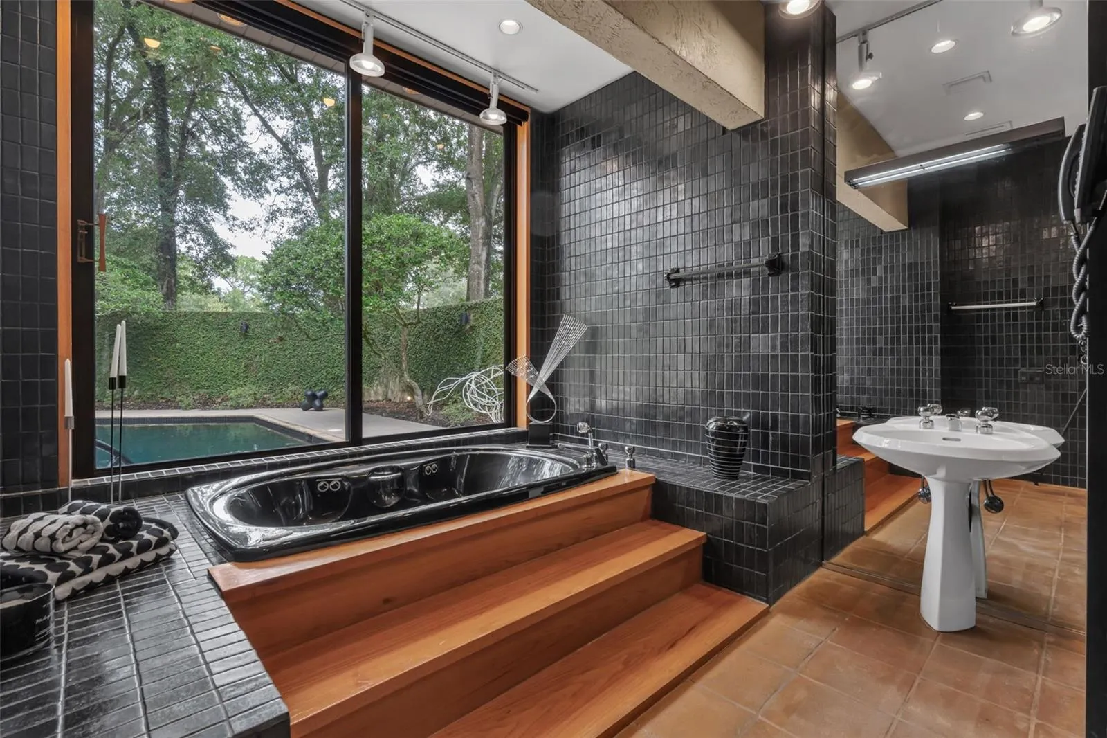 The Owner's Bathing Area with tub overlooking the Pool