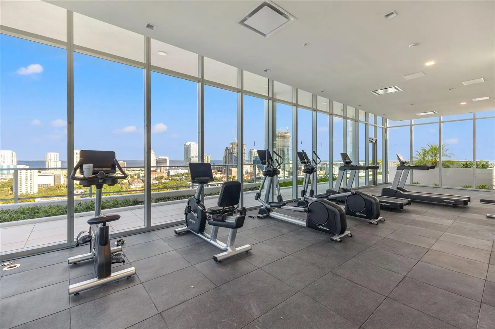 Rooftop fitness center with 3 full window walls with amazing views as you work out
