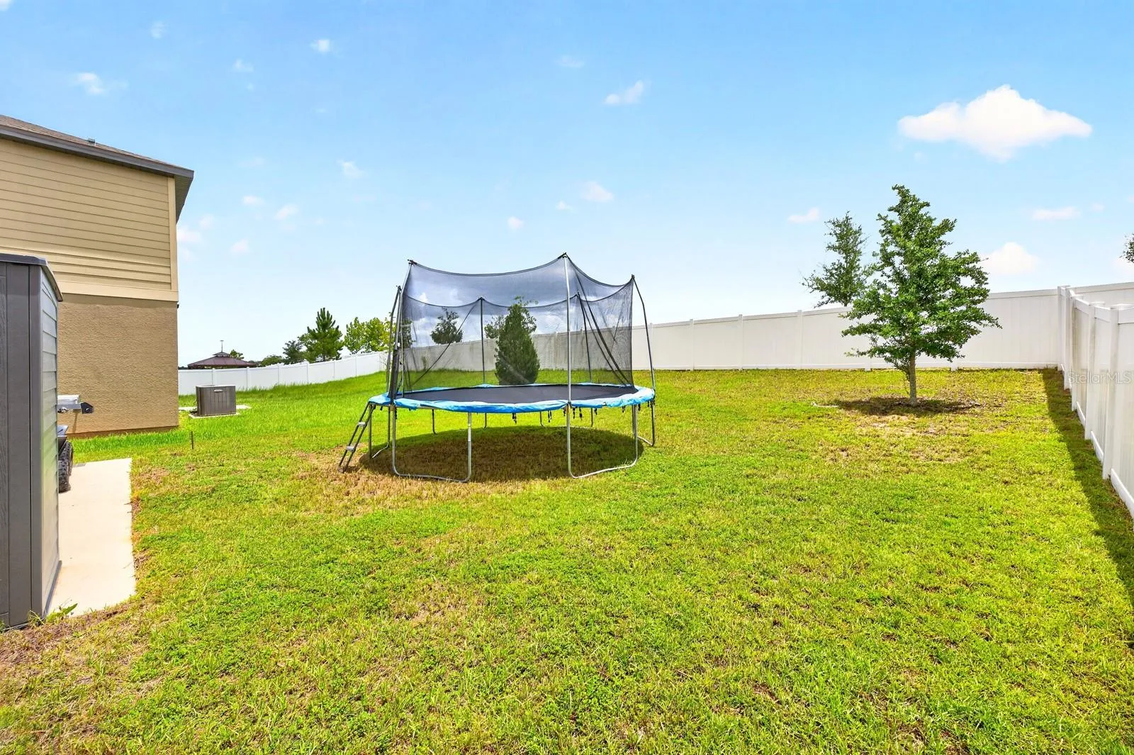 Step out to the backyard, where you'll find a patio overlooking the expansive, partially fenced yard complete with a STORAGE SHED.