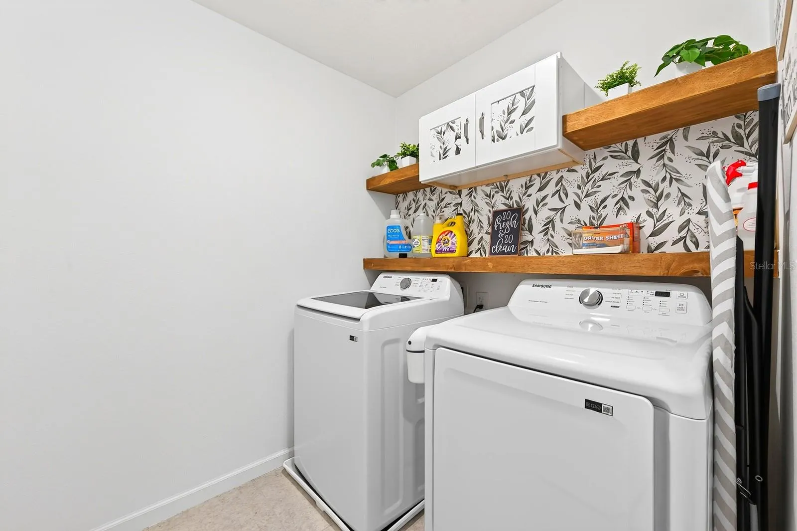 The upstairs Laundry Room includes the washer, dryer, and BUILT-IN SHELVING to keep everything organized.