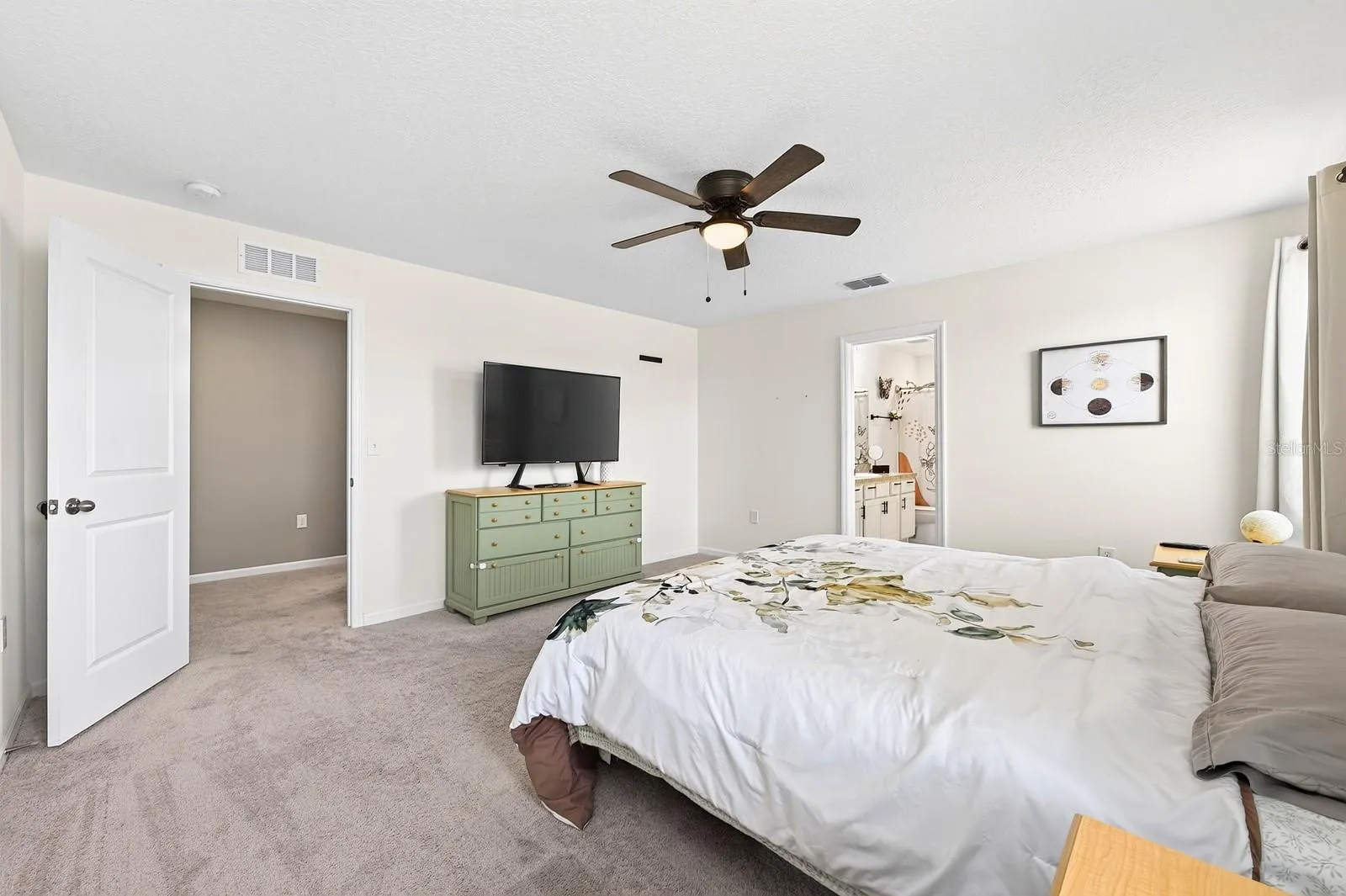 The spacious Primary Suite features a huge walk-in closet and a PRIVATE EN SUITE BATH, designed for comfort and convenience.