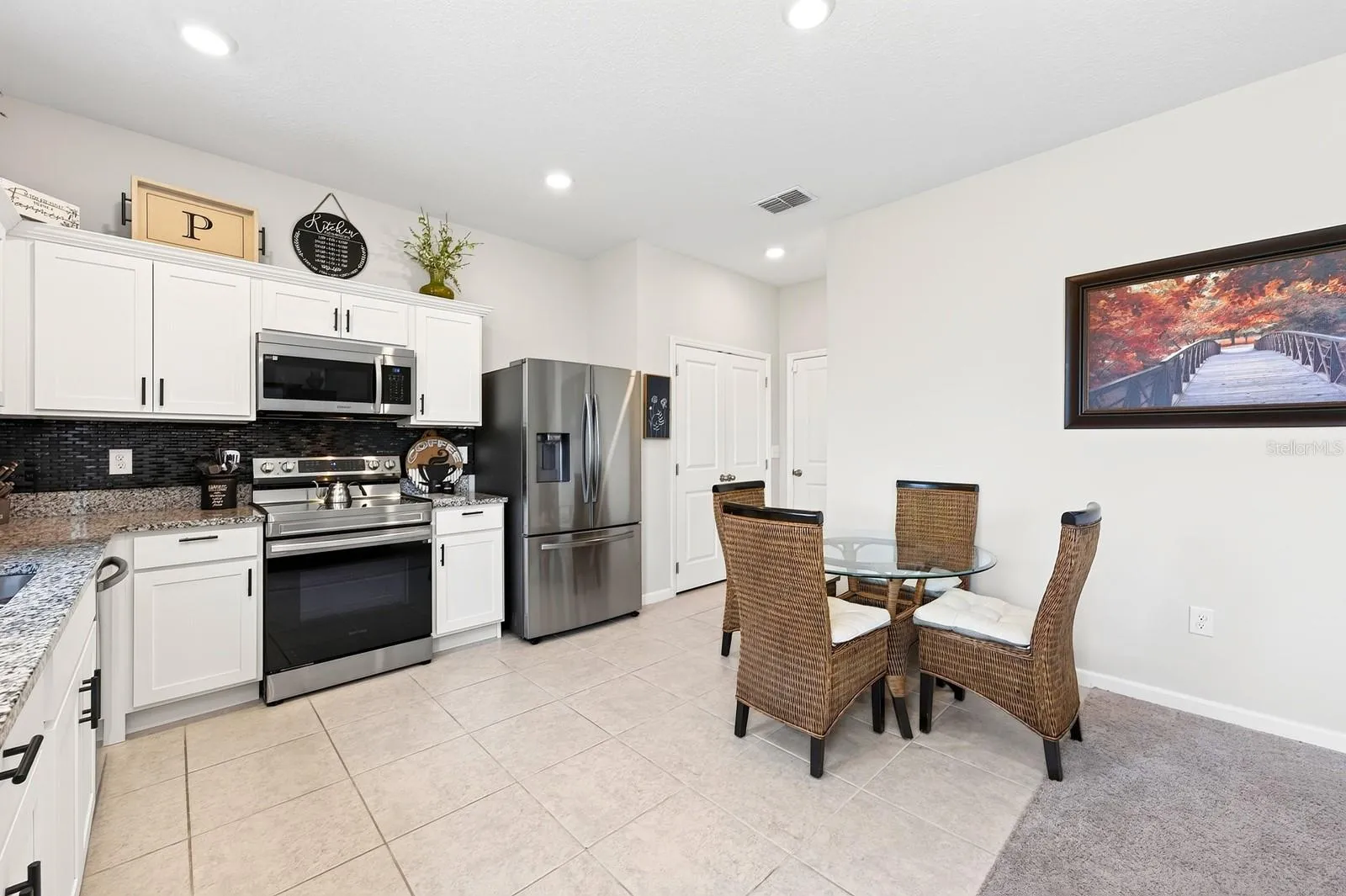 A SPACIOUS EAT-IN DINING AREA is perfect for casual family meals or gathering with friends.
