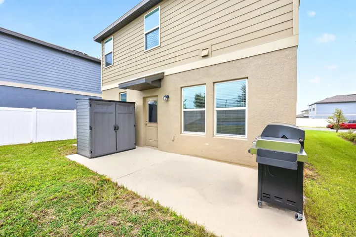 Step out to the backyard, where you'll find a patio overlooking the expansive, partially fenced yard complete with a STORAGE SHED.