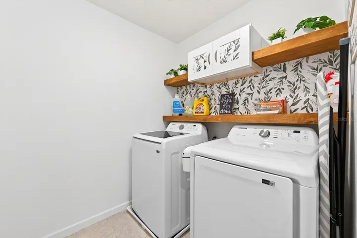 The upstairs Laundry Room includes the washer, dryer, and BUILT-IN SHELVING to keep everything organized.