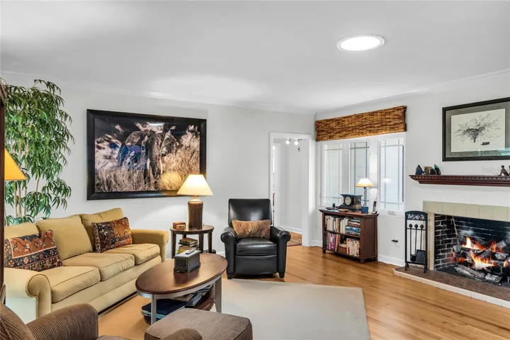Living room with beautiful hardwood floors, gas fireplace and lots of natural light