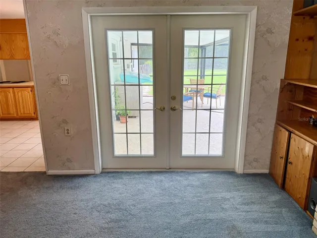 French doors from family room to pool area