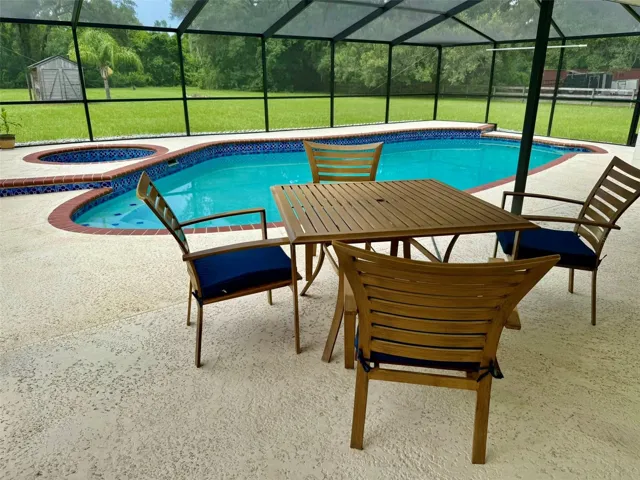 Enclosed pool and spa, covered seating area