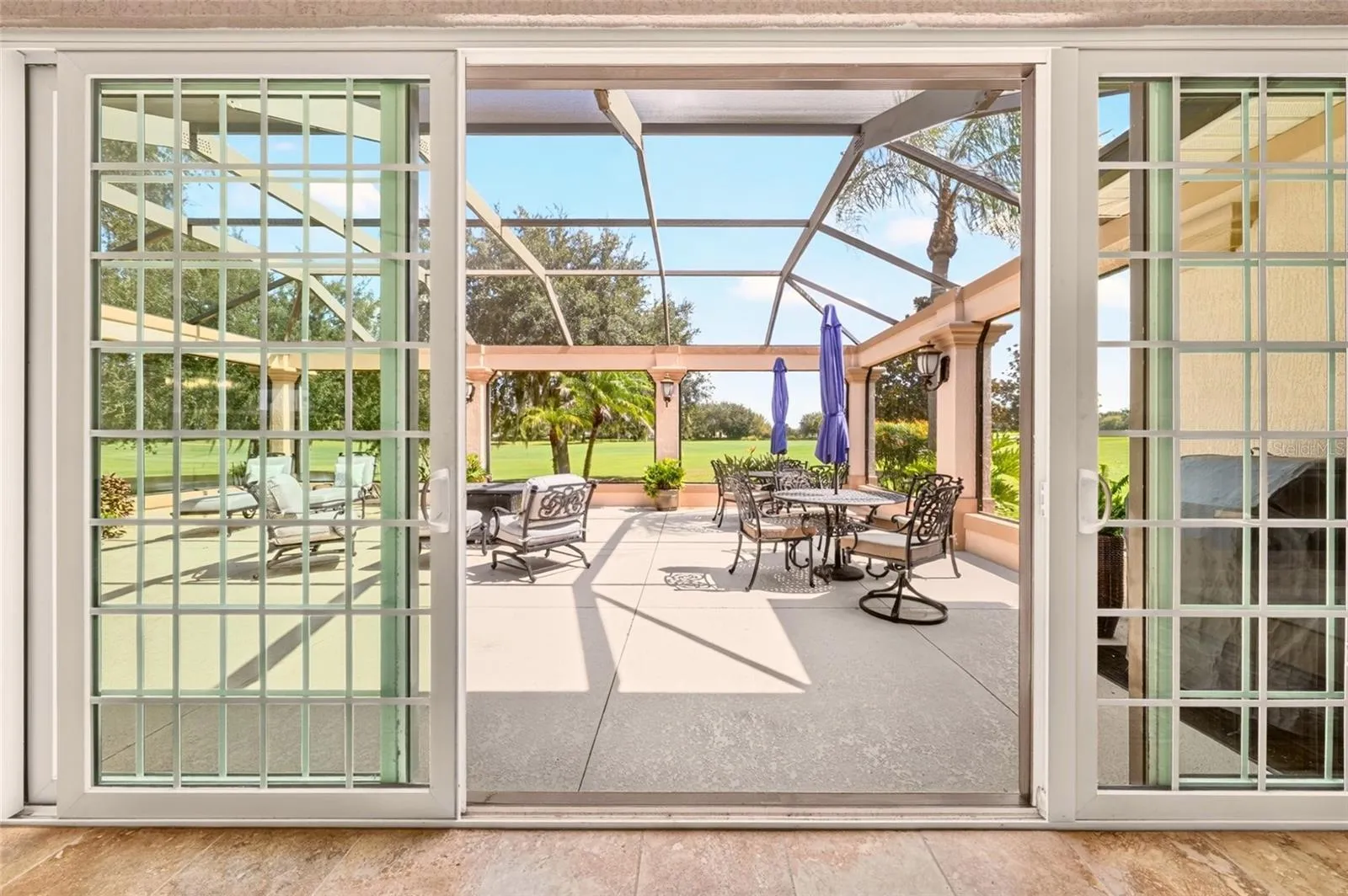 Sliding doors from the Florida room open to screened lanai