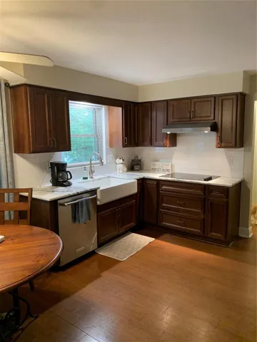 Kitchen with farm house sink, cook top and vented hood