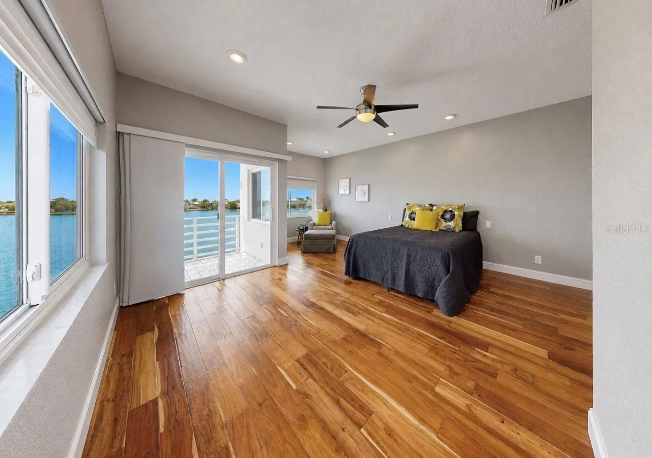 Primary bedroom with 2 walk-in closets and private balcony overlooking the Bay