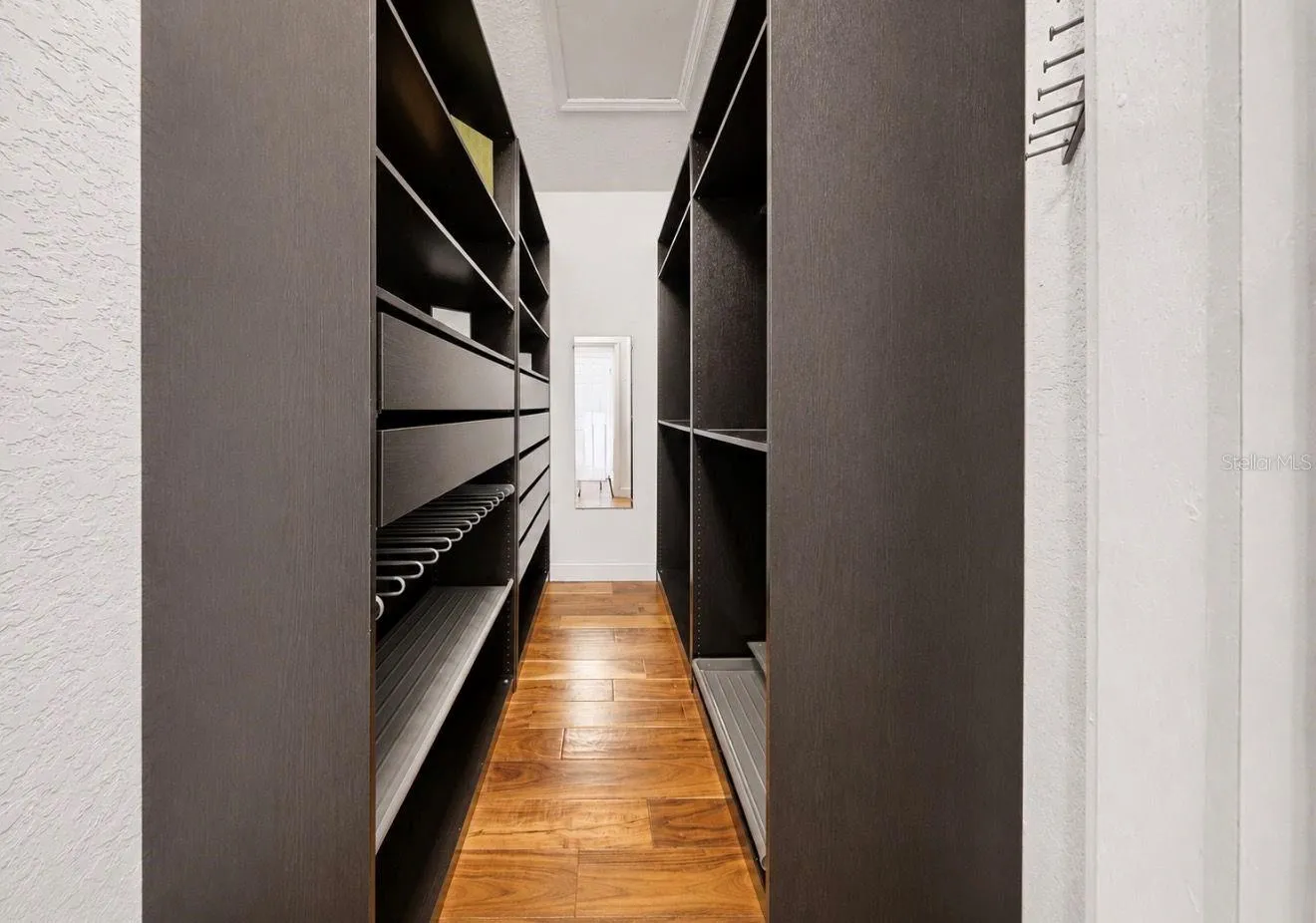 Custom closet system in one of the walk-in primary bedrooms closets
