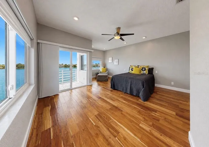Primary bedroom with 2 walk-in closets and private balcony overlooking the Bay