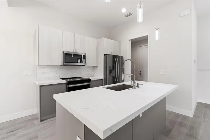 Kitchen Features Breakfast Bar and Stainless Appliances