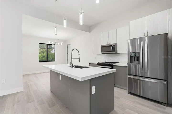 Kitchen Features Quartz Countertops and Stainless Steel Appliances