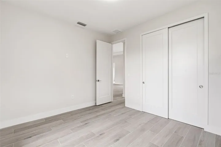 Bedroom 3 Features Porcelain Plank Tile Flooring