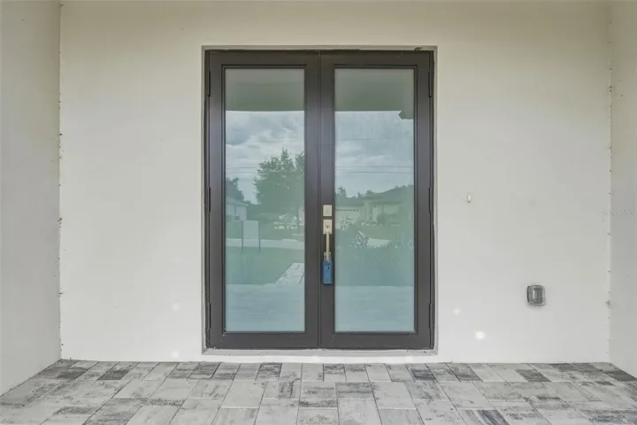Covered Front Entry with Paver Walkway and Elegant Design
