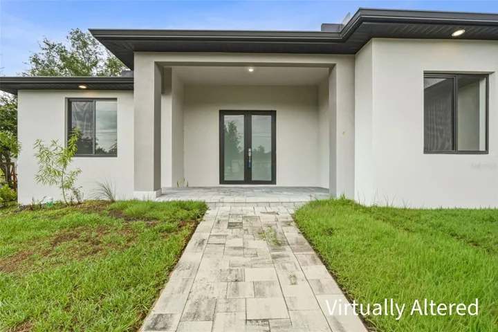 Paver Walkway Leads to Covered Porch and Double Frosted Glass Front Door