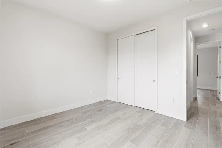 Bedroom 4 Features Natural Light & Porcelain Plank Tile Flooring