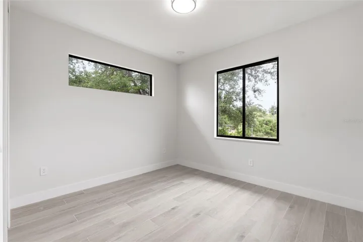 Bedroom 3 Features Porcelain Plank Tile Flooring & Clerestory Window