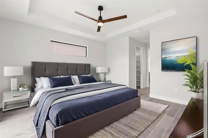 Virtually Staged Spacious Primary Bedroom with Tray Ceiling & Clerestory Window