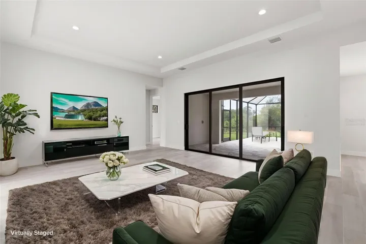 Virtually Staged Living Room with Pocketing Sliders to the Lanai