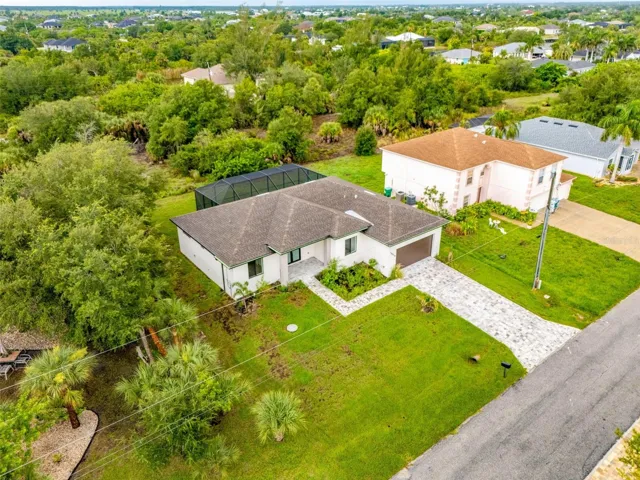 Green Belt Surrounds Home with Paver Driveway